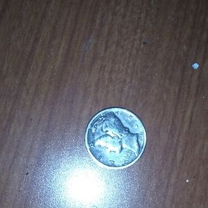 A 1943 silver dime with a lady on it.